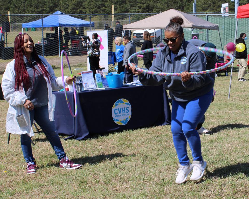 A 2022 Donamatrix Fitness Festival attendee has fun with a hula hoop.