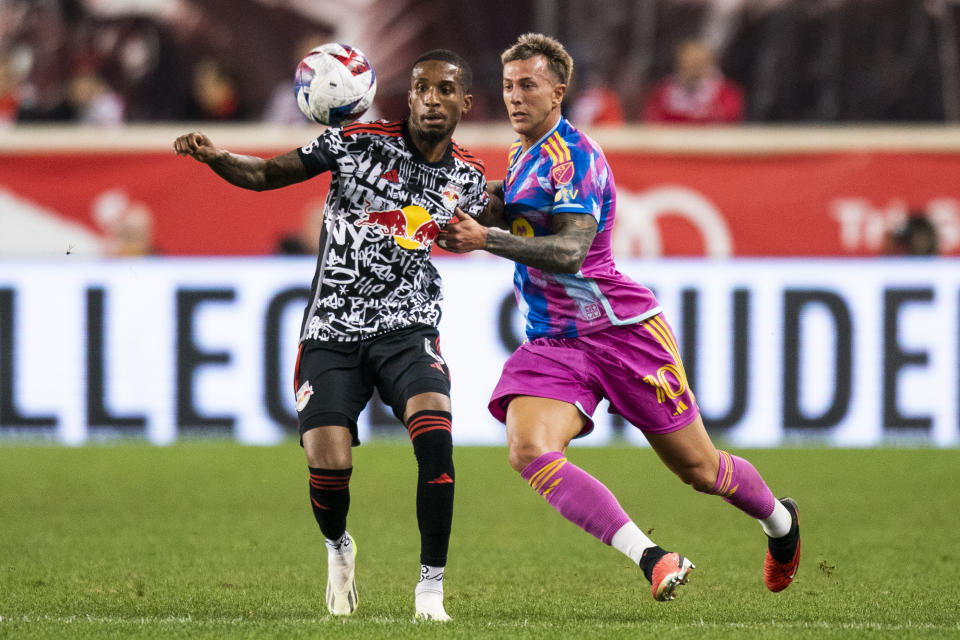 Toronto FC forward Federico Bernardeschi, right, fights for the ball against New York Red Bulls defender Kyle Duncan, left, during an MLS soccer match Saturday, Oct. 7, 2023, in Harrison, N.J. (AP Photo/Eduardo Munoz Alvarez)