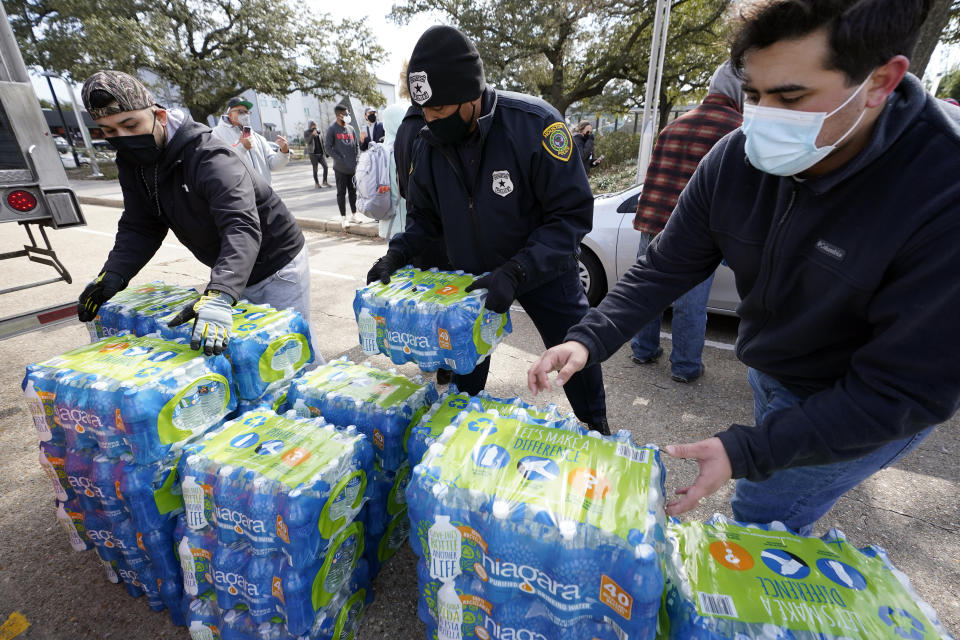 Donated water is distributed to residents, Thursday, Feb. 18, 2021, in Houston. Houston and several surrounding cities are under a boil water notice as many residents are still without running water in their homes. (AP Photo/David J. Phillip)