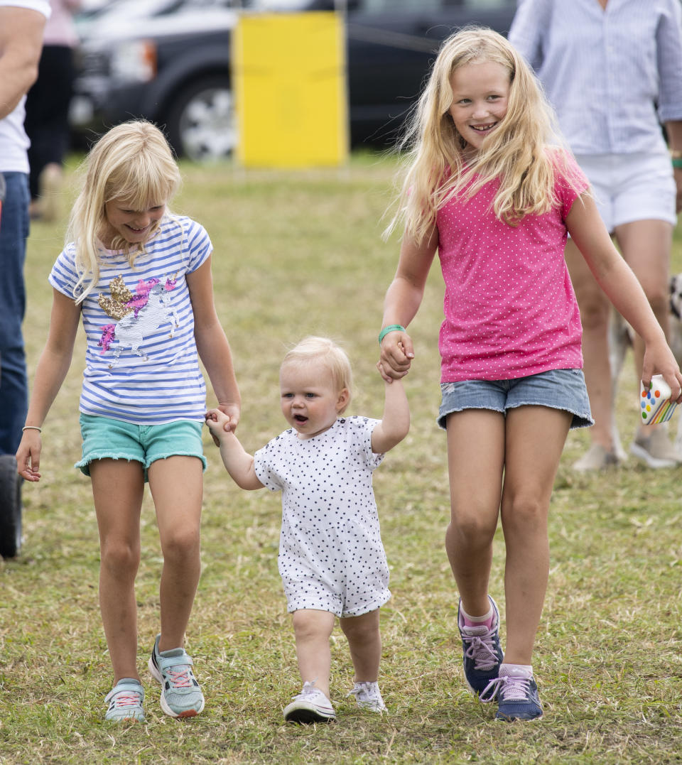 6. Savannah Phillips and Isla Phillips hold hands with Lena Tindall