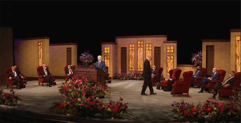 This Saturday, Oct. 3, 2020, video image streamed by The Salt Lake Temple of The Church of Jesus Christ of Latter-day Saints, shows church President Russell M. Nelson, at podium, with top leaders during the opening of the 190th Semiannual General Conference at the Conference Center Theater on Temple Square in Salt Lake City. The twice-annual conference kicked off Saturday without anyone attending in person and top leaders sitting some 6-feet apart inside an empty room as the faith takes precautions to avoid the spread of the coronavirus. (The Church of Jesus Christ of Latter-day Saints via AP)