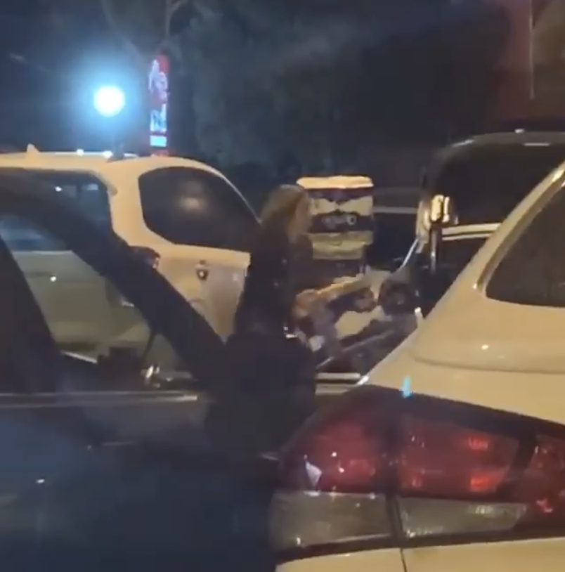 Pictured is a woman loading her car with 12 packs of toilet paper at Springvale in Melbourne. 