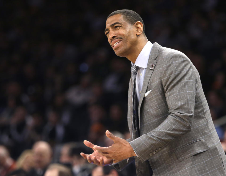 Connecticut head coach Kevin Ollie instructs his team in the first half of a regional final against Michigan State at the NCAA college basketball tournament on Sunday, March 30, 2014, in New York. (AP Photo/Frank Franklin II)
