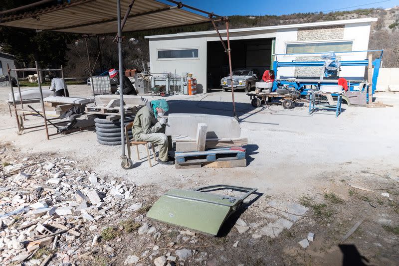 Artists work on a life size Mercedes monument in Imotski