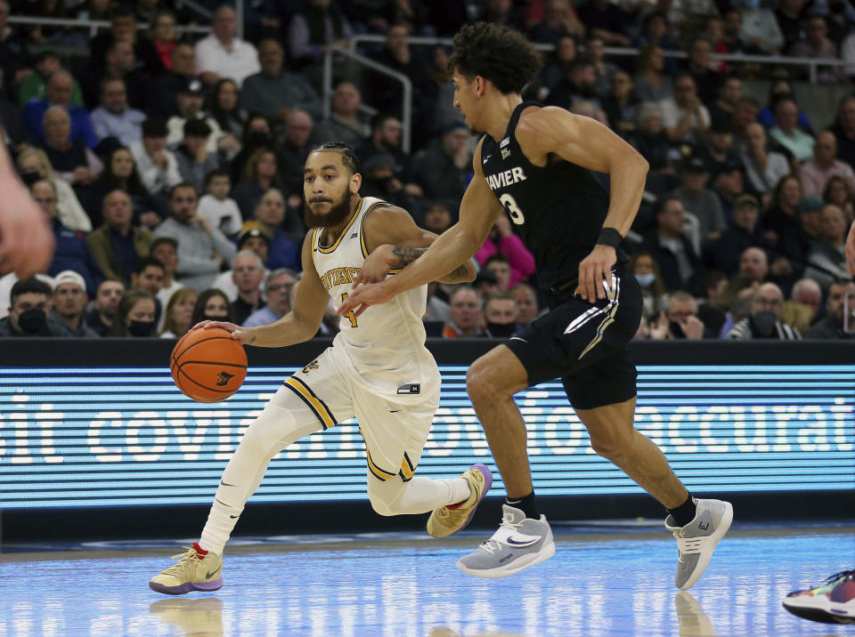 Providence's Jared Bynum (4) is defended by Xavier's Colby Jones (3) during the first half of an NCAA college basketball game Wednesday, Feb. 23, 2022, in Providence, R.I. (AP Photo/Stew Milne)