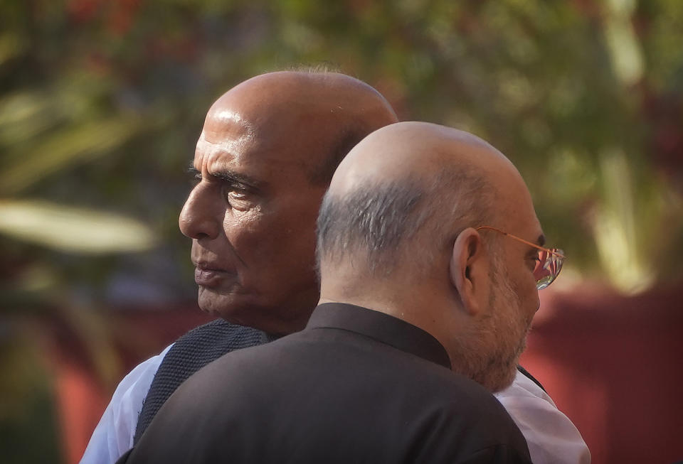 Indian Defence Minister Rajnath Singh, left, and Home Minister Amit Shah talk to their cabinet colleagues as they wait to pay respect to the martyrs of 2001 terror attack on Parliament House, in New Delhi, Tuesday, Dec. 13, 2022. Soldiers from India and China clashed last week along their disputed border, India's defense minister said Tuesday, marking yet another serious face-off along the contested frontier since June 2020 when troops from the two rival countries were killed in a deadly brawl. (AP Photo/Manish Swarup)