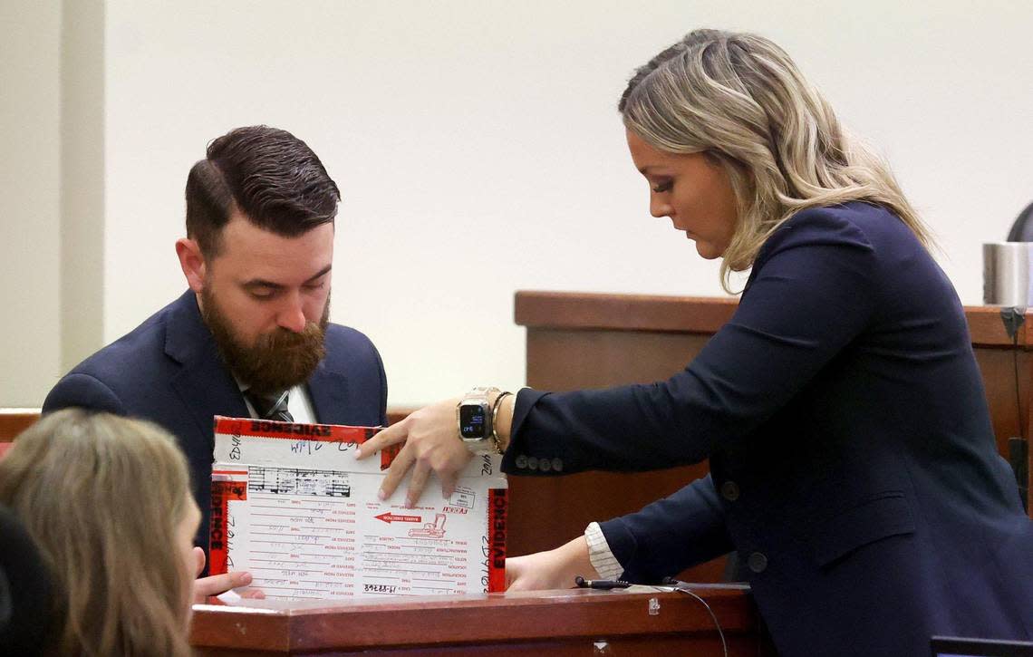 Crime-scene technician James Van Gorkom, left, confirms evidence with Assistant Criminal District Attorney Ashlea Deener during the third day of Aaron Dean’s trial on Wednesday, December 7, 2022, in Fort Worth. Dean fatally shot Atatiana Jefferson in 2019 while responding to a call at her home.