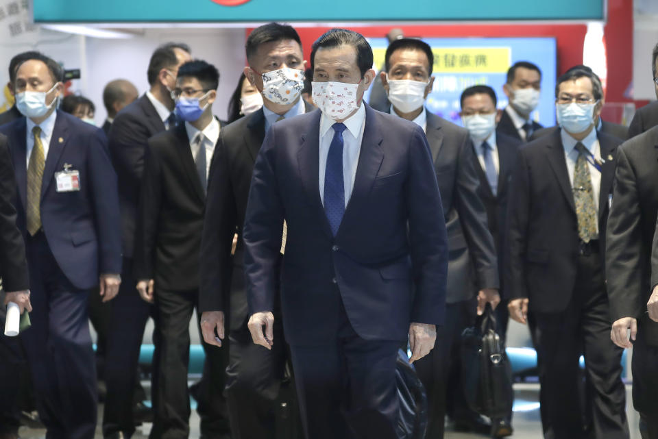 Former Taiwan President Ma Ying-jeou, center, walks to a gate before leaving for China at Taoyuan International Airport in Taoyuan City, Northern Taiwan, Monday, March 27, 2023. Ma departed for China Monday on a 12-day tour, a day after Taiwan lost another one of its diplomatic allies to China. (AP Photo/Chiang Ying-ying)