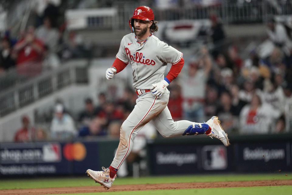 Philadelphia Phillies designated hitter Bryce Harper (3) runs after hitting a solo homer against the Atlanta Braves during the sixth inning of Game 1 of a baseball NL Division Series, Saturday, Oct. 7, 2023, in Atlanta. (AP Photo/John Bazemore)