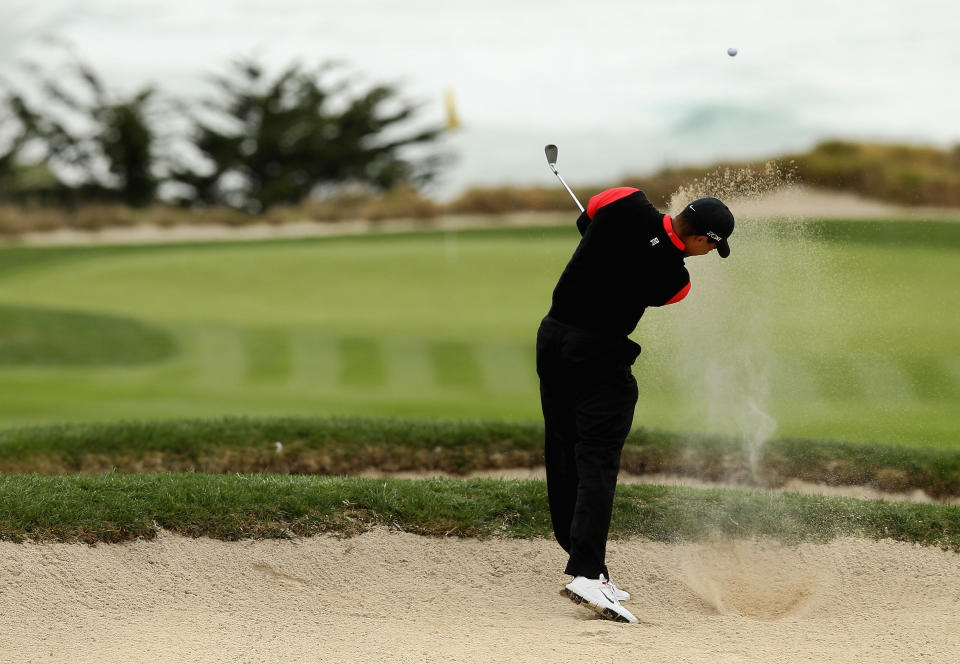 PEBBLE BEACH, CA - FEBRUARY 12: Tiger Woods hits out of a bunker on the tenth hole during the final round of the AT&T Pebble Beach National Pro-Am at Pebble Beach Golf Links on February 12, 2012 in Pebble Beach, California. (Photo by Ezra Shaw/Getty Images)