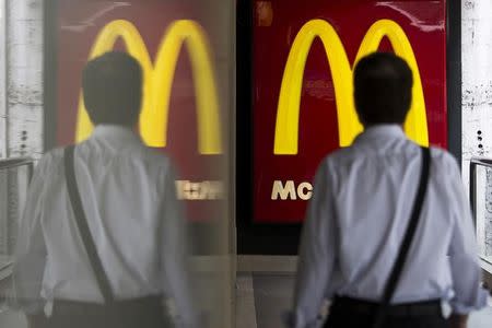 A customer walks into a McDonald's store in Hong Kong July 25, 2014. REUTERS/Tyrone Siu