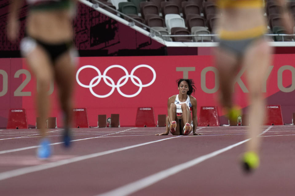 Katarina Johnson-Thompson, of Britain, reacts after dropping to the track during a heat in the heptathlon women's 200-meter at the 2020 Summer Olympics, Wednesday, Aug. 4, 2021, in Tokyo. (AP Photo/Petr David Josek)