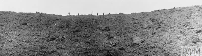 British soldiers stand looking into the huge mine crater at Messines Ridge, blown up on the morning of the battle, June 11, 1917