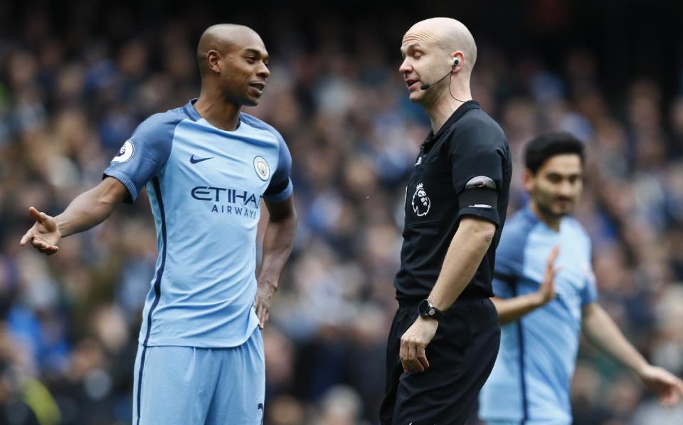 Britain Football Soccer - Manchester City v Chelsea - Premier League - Etihad Stadium - 3/12/16 Manchester City's Fernandinho with referee Anthony Taylor Action Images via Reuters / Jason Cairnduff Livepic EDITORIAL USE ONLY. No use with unauthorized audio, video, data, fixture lists, club/league logos or "live" services. Online in-match use limited to 45 images, no video emulation. No use in betting, games or single club/league/player publications. Please contact your account representative for further details.