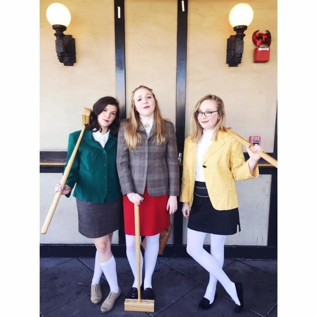three girls in blazers with croquet mallets