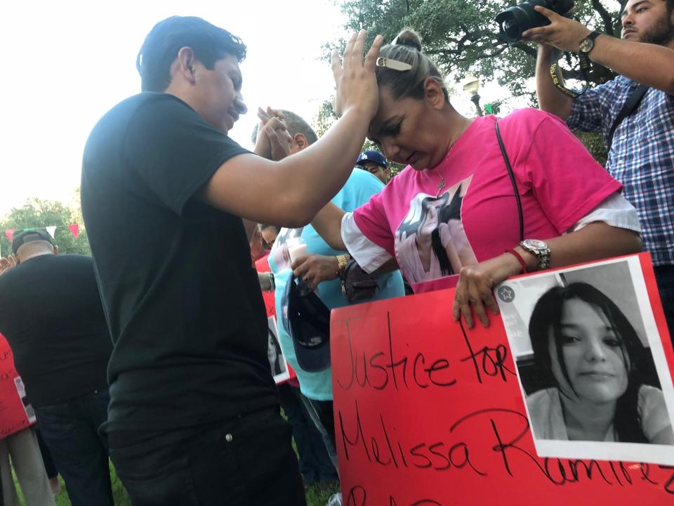 Members of Melissa Ramirez's family pray during a candlelight vigil in Laredo on Tuesday, Sept. 18. Ramirez was the first of four women allegedly slain by Border Patrol agent Juan David Ortiz, on Sept. 3.