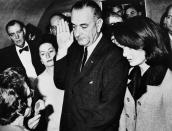 <p>Following the assassination of President John F. Kennedy, Vice President Lyndon B. Johnson is sworn into the office of the presidency aboard Air Force One.</p>