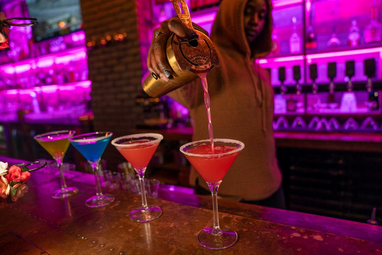 Ciara Kelly, bar manager at District 78, in Detroit, pours colorful martinis on Thursday, Oct. 19, 2023.