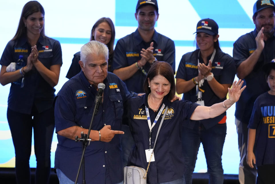 Presidential candidate Jose Raul Mulino, left, stands beside Marta Linares de Martinelli, the wife of former Panamanian President Ricardo Martinelli, as he addresses supporters after winning on the day of the general electing in Panama City, Sunday, May 5, 2024. (AP Photo/Matias Delacroix)