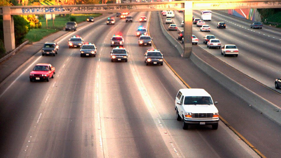 In this June 17, 1994, file photo, a white Ford Bronco, driven by Al Cowlings carrying O.J. Simpson, is trailed by Los Angeles police cars as it travels on a freeway in Los Angeles. - Joseph R. Villarin/AP