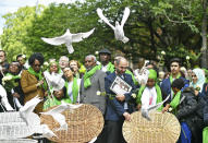 People gather as doves are released outside St Helens church, following a service to mark the two-year anniversary of the Grenfell Tower block fire, in London, Friday, June 14, 2019. Survivors, neighbors and politicians including London Mayor Sadiq Khan attended a church service of remembrance on Friday for the Grenfell Tower blaze, the deadliest fire on British soil since World War II. (Dominic Lipinski/PA via AP)