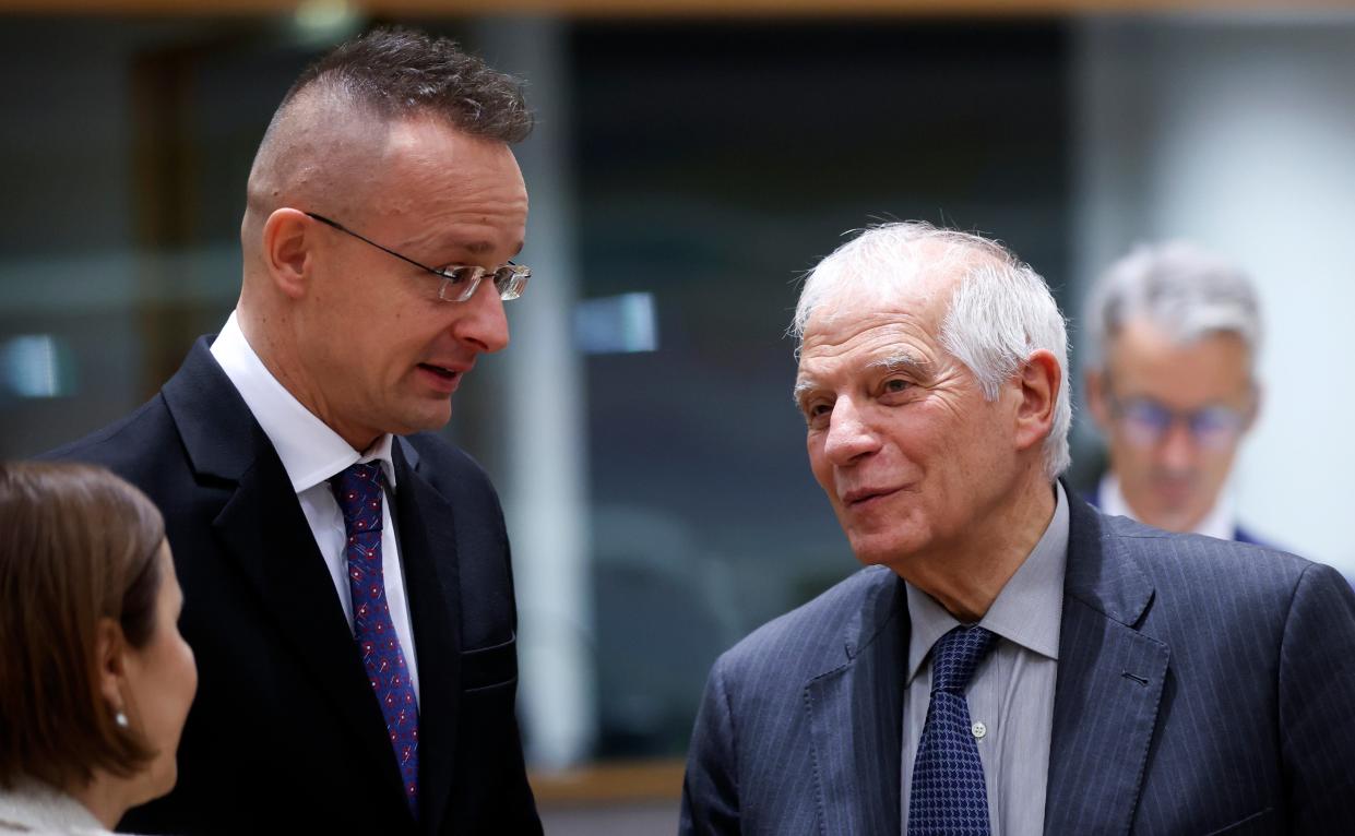 Top EU official Josep Borrell (R), speaks with the Hungarian foreign minister in Brussels ahead of discussions on Ukraine’s membership to the bloc (EPA)