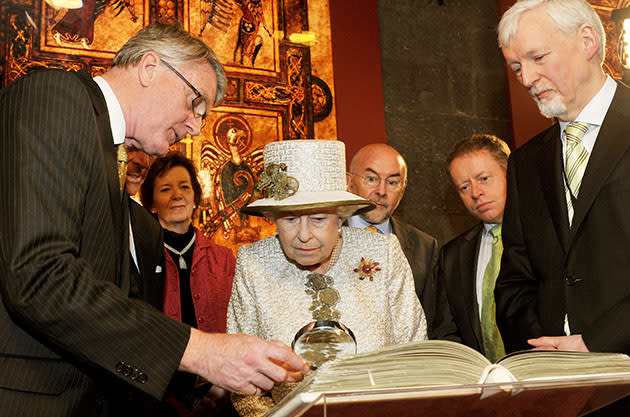 Queen Elizabeth II examines the Book of Kells on May 17, 2011. (John Stillwell/Getty Images)