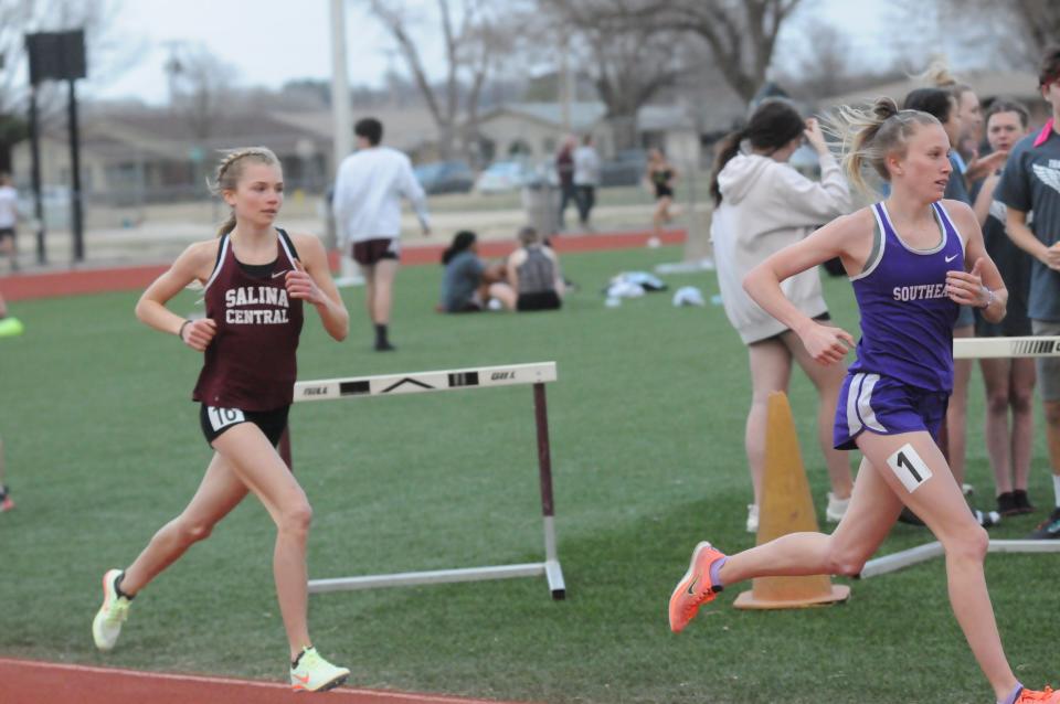 Southeast of Saline's Jentrie Alderson leads Salina Central's Katelyn Rupe in the 1,600-meter run of the Saline County Invitational Tuesday, March 29 2022 at Salina Stadium.