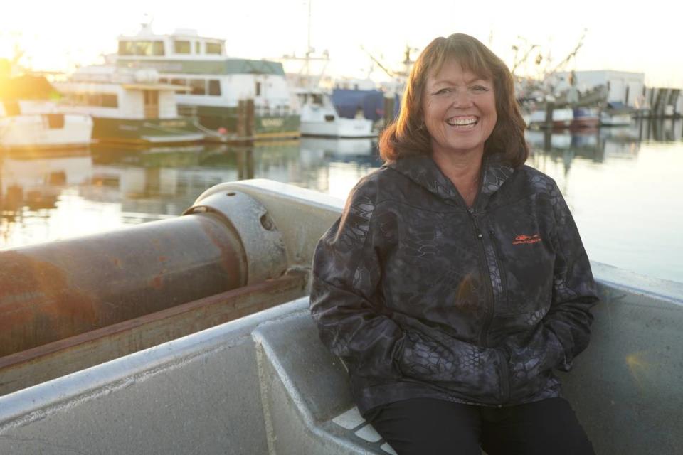 Ellie Kinley, a member of the Lummi (Lhaq’temish) Nation, sits on her fishing boat in Bellingham Bay’s Squalicum Harbor on Nov. 17, 2023. Kinley is the last Indigenous reef net permit holder of the ancient salmon fishing practice but didn’t use her reef netting rig this year due to economic realities.
