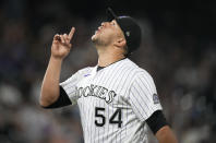 Colorado Rockies relief pitcher Carlos Estevez reacts after getting Milwaukee Brewers' Avisail Garcia to hit into a double play to end the top of the eighth inning of a baseball game Friday, June 18, 2021, in Denver. (AP Photo/David Zalubowski)