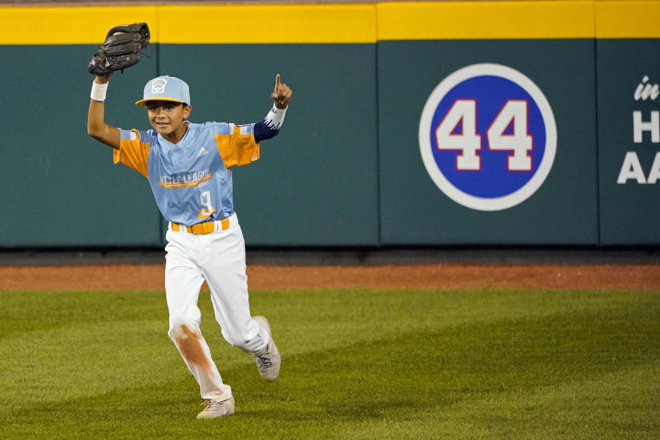 Honolulu center fielder Kaikea Patoc-Young celebrates after catching a ball hit by Taylor, Mich.'s Lucas Farner for the final out a baseball game at the Little League World Series tournament in South Williamsport, Pa., Wednesday, Aug. 25, 2021. Hawaii won 2-0. (AP Photo/Tom E. Puskar)