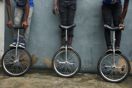 Members of the GKB academy, a unicycle club, pose for a photo with their unicycles during a training session in Lagos