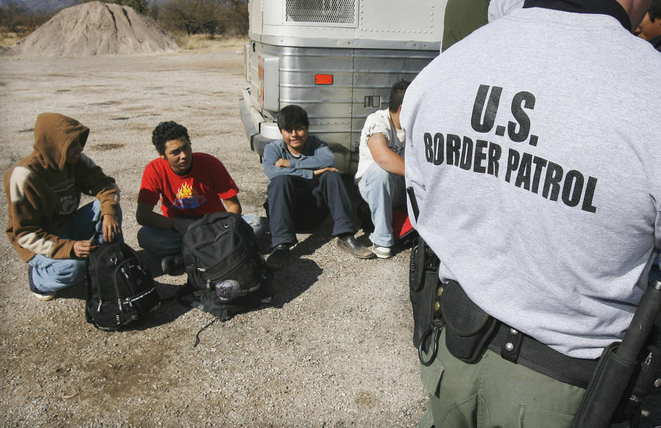FILE - In this Jan. 19, 2007, file photo, Border Patrol agents processes a number of illegal immigrants caught entering the United States, in Sasabe, Arizona. Arizona is still widely viewed in Mexico as the most anti-Mexico state in the U.S., even if the tough anti-migrant law behind that perception has been largely voided. But Arizona’s leaders are logging lots of miles to put a new face on their home state. Mexicans are already Arizona’s biggest foreign trade partners, with the state exporting $7 billion worth of goods last year, the U.S. Commerce Department says. (AP Photo/Ross D. Franklin, File)