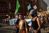 Performance activists with the climate protest group Extinction Rebellion stage a demonstration as they march through central Manchester in north-west England on September 1, 2020, at the start of their new season of "mass rebellions". - Climate protest group Extinction Rebellion will target Britain's parliament as part of "mass rebellions" starting from September 1. Other actions will take place around the country. (Photo by OLI SCARFF / AFP) (Photo by OLI SCARFF/AFP via Getty Images)