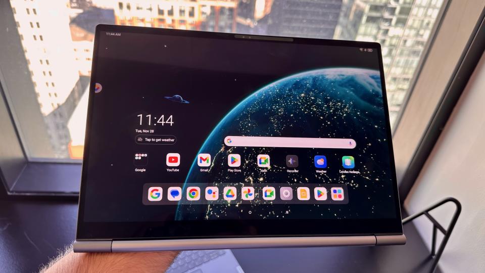 The Lenovo ThinkBook Plus Gen 5 Hybrid in tablet form, held in hand like a tray.