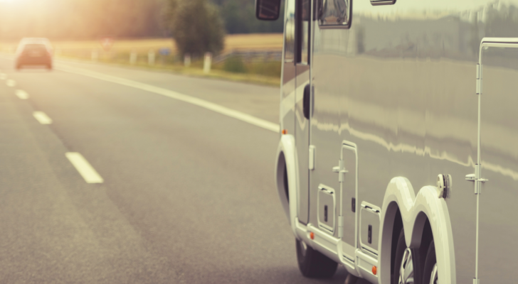 A photo of an RV driving down the road.