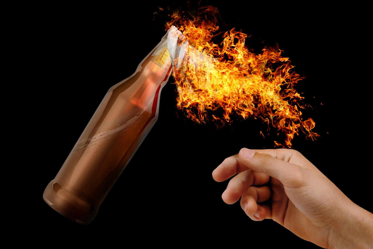 Human hand throwing Molotov Cocktail (Getty Images)