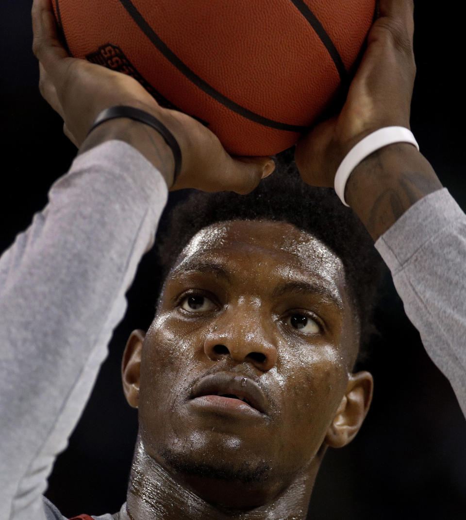 FILE - In this March 14, 2018, file photo, Kansas forward Silvio De Sousa practices for an NCAA college basketball first round game, in Wichita, Kan. Kansas forward Silvio De Sousa, whose name surfaced as part of the FBI’s investigation into corruption in college basketball, will be withheld from competition pending a review of his eligibility. Jayhawks coach Bill Self said in a statement before appearing at the Big 12’s annual media day Wednesday, Oct. 24,2018, that the sophomore forward would be held out beginning with Thursday’s exhibition game. (AP Photo/Charlie Riedel, File)