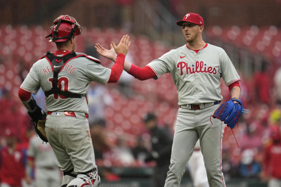 Philadelphia Phillies catcher J.T. Realmuto (10) and relief pitcher Jeff Hoffman celebrate a 4-3 victory over the St. Louis Cardinals in a baseball game Wednesday, April 10, 2024, in St. Louis. (AP Photo/Jeff Roberson)