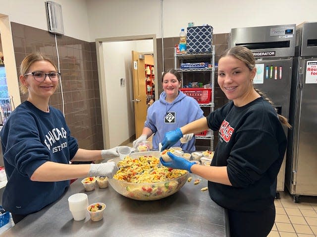 Isabella Brogan, left, Jasmine Philbeck and Aubrey Kurek prepare pasta salad for the guests staying at the Ronald McDonald House Charities of Northwest Ohio.