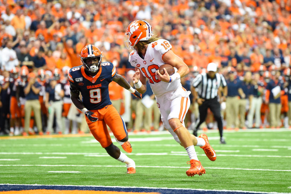 Clemson Tigers quarterback Trevor Lawrence (16) looks back at Syracuse Orange defensive back Evan Foster (9) while running into the end zone for a touchdown. (USAT)