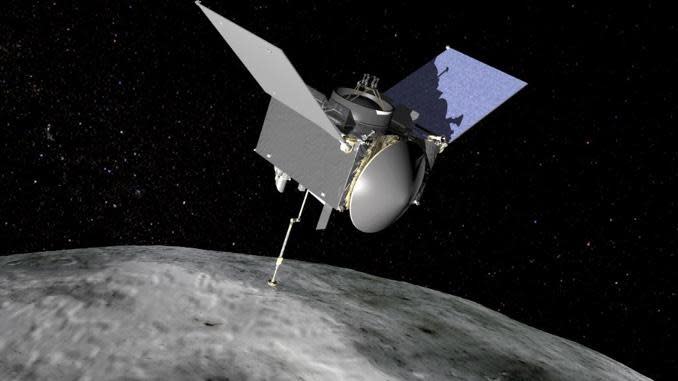 An artist's impression of NASA's OSIRIS-REx spacecraft with its sample collection mechanism extended on the end of the probe's robot arm. Four years after launch from Cape Canaveral, the spacecraft was loaded with updated navigation data early Tuesday for an attempt to collect samples from the surface of rocky asteroid known as Bennu. / Credit: NASA