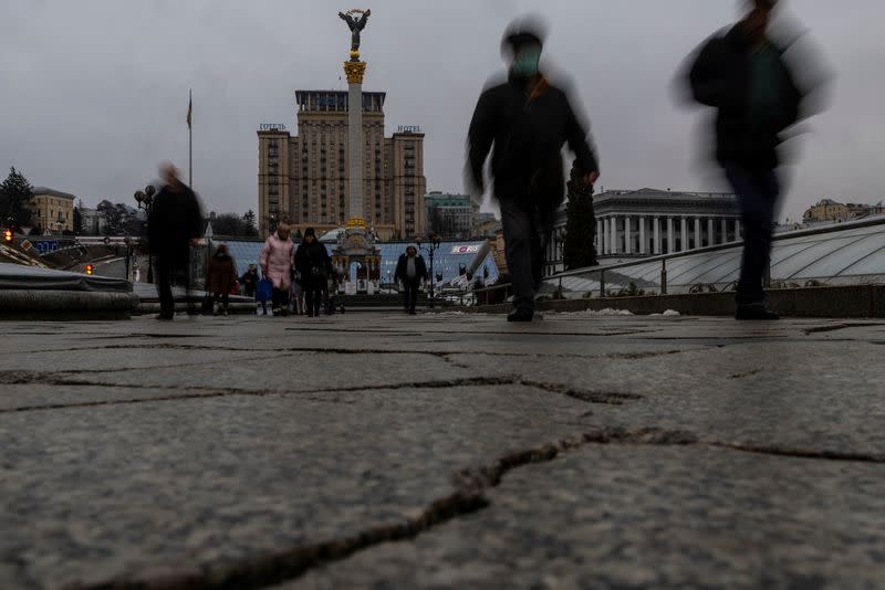 Local residents walk along Independence Square in downtown Kyiv