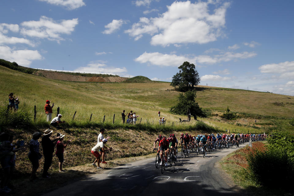 The pack rides during the eighth stage of the Tour de France cycling race over 200 kilometers (125 miles) with start in Macon and finish in Saint Etienne, France, Saturday, July 13, 2019. (AP Photo/Christophe Ena)