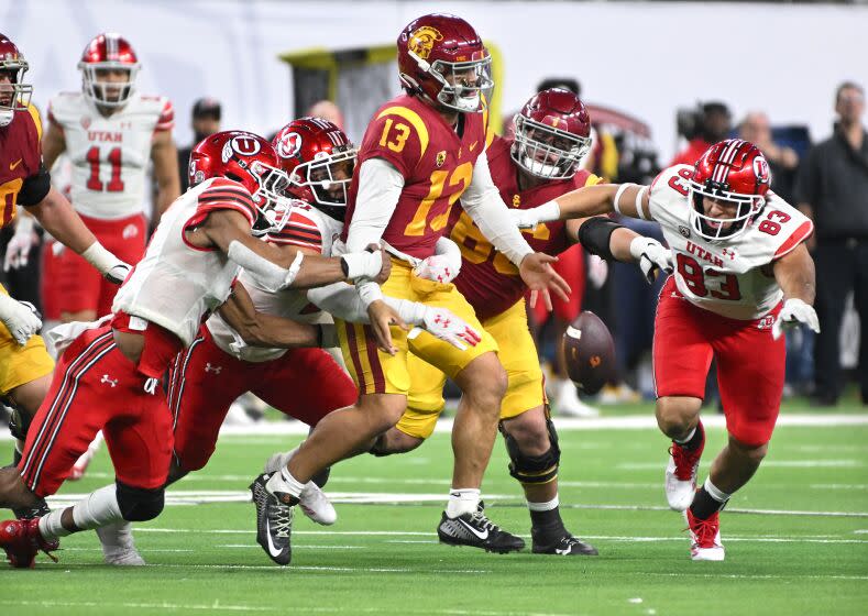 Las Vegas, CA - December 02: Utah Utes linebacker Mohamoud Diabate, left, forces a fumble.