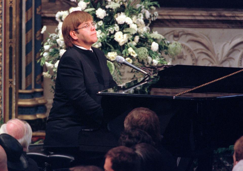 **  FILE  **  Elton John plays a specially re-written version of his song "Candle in the Wind" during the funeral service for Diana, Princess of Wales at London's Westminster Abbey in this Saturday, Sept. 6, 1997 file photo. (AP Photo/Paul Hackett, Pool)