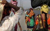 In this Sunday, March 29, 2020, file photo, migrant workers walk to their villages along the Mumbai Pune highway during 21-day countrywide lockdown in Mumbai, India. Over the past week, India’s migrant workers - the mainstay of the country’s labor force - spilled out of big cities that have been shuttered due to the coronavirus and returned to their villages, sparking fears that the virus could spread to the countryside. It was an exodus unlike anything seen in India since the 1947 Partition, when British colothe subcontinent, with the 21-day lockdown leaving millions of migrants with no choice but to return to their home villages. (AP Photo/Rajanish Kakade, File)