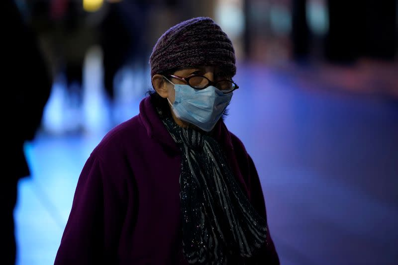 A woman wearing a mask is seen on a street in Shanghai