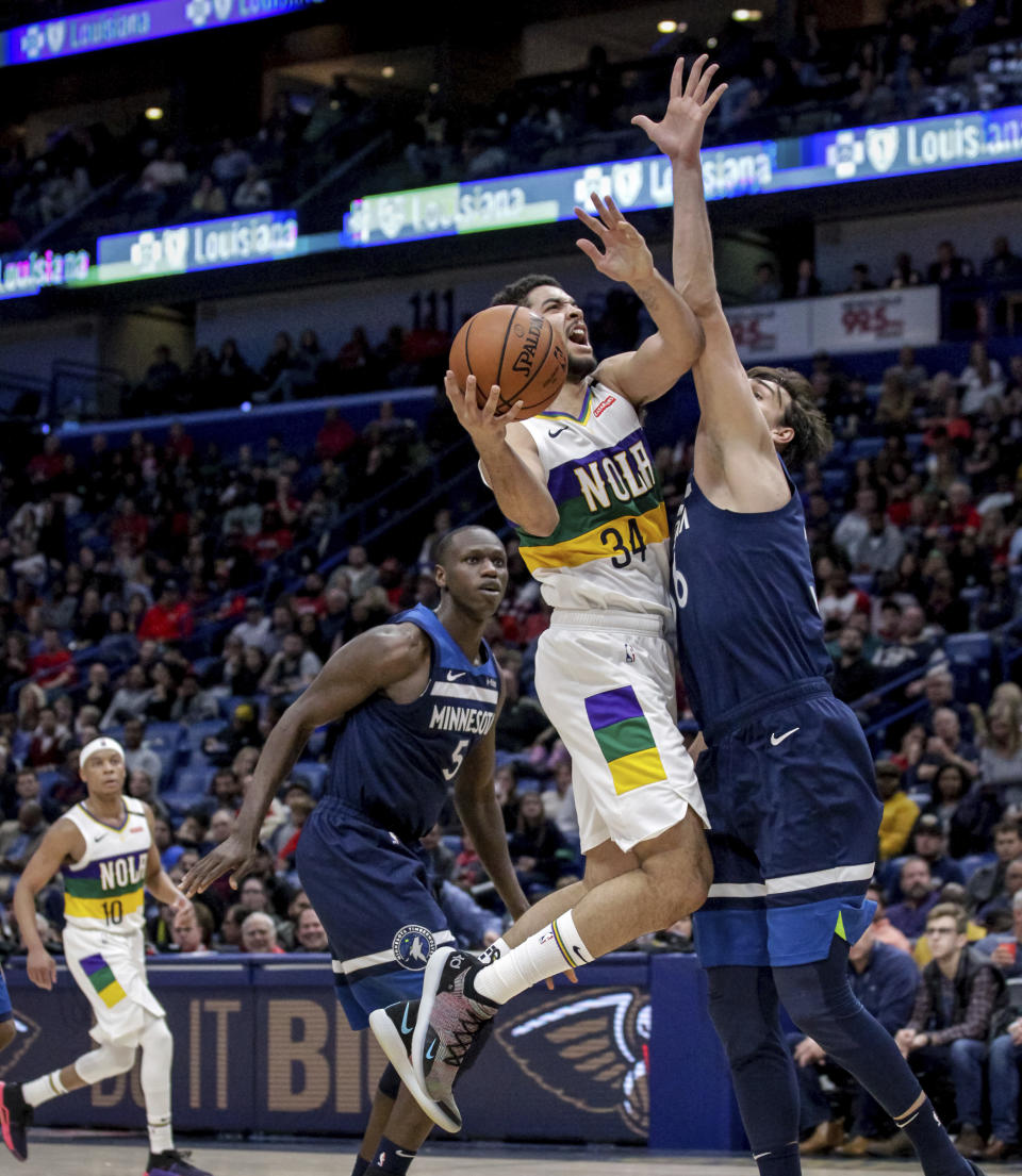 New Orleans Pelicans guard Kenrich Williams (34) shoots over Minnesota Timberwolves forward Dario Saric during the second half of an NBA basketball game in New Orleans, Friday, Feb. 8, 2019. The Pelicans won 122-117. (AP Photo/Scott Threlkeld)