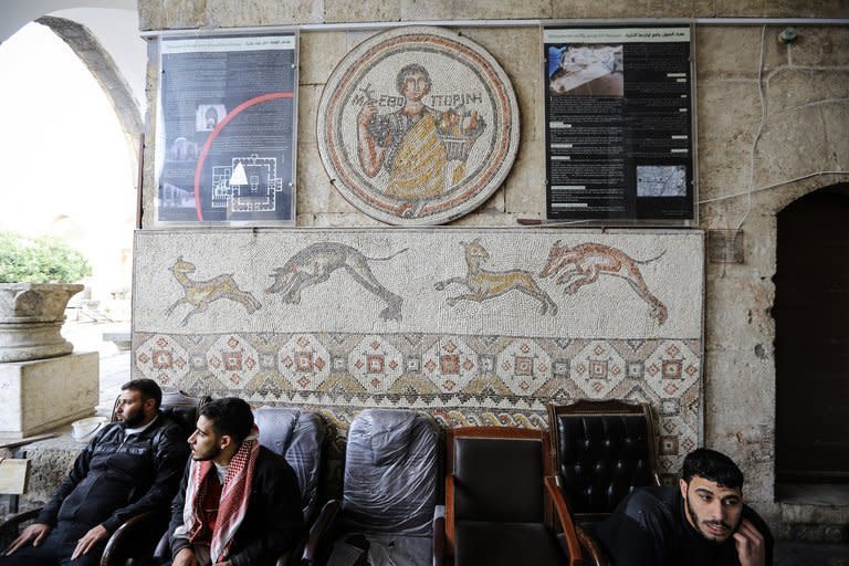 Syrian rebel fighters sit below Roman-era mosaics in Maaret Al-Numan. At least 18 ancient mosaics depicting scenes from Homer's "The Odyssey" have been stolen in northern Syria, the culture minister was quoted as saying on Sunday